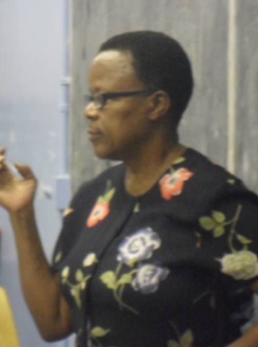 Mary Henry teaching a caregiver training class at the chalkboard
