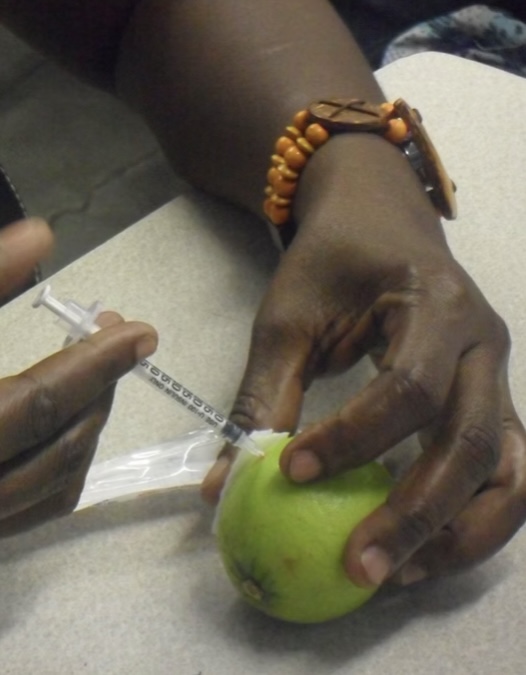 Caregiver trainees practising clinical skills in class